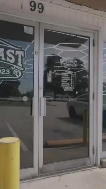 The West Coast Barbershop entrance with 99 above the door at Southport Road